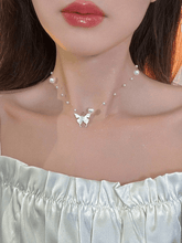 Faux pearl necklace with butterfly charm